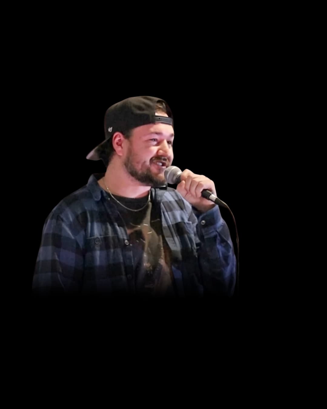 Dom Vallee on stage with a microphone