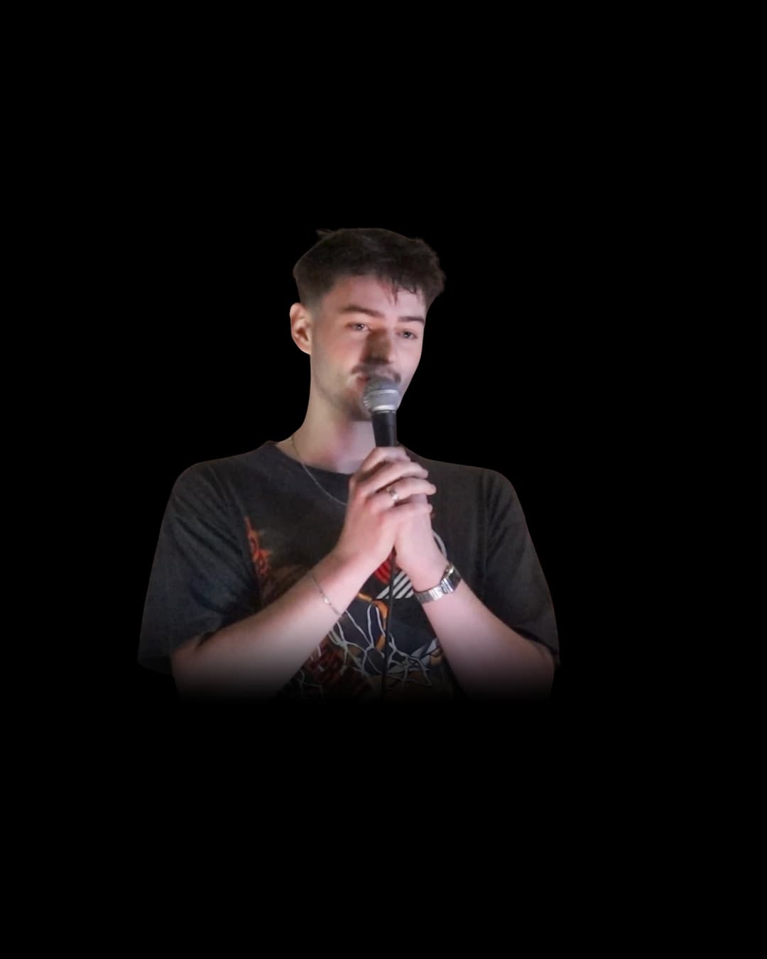 Ethan Johannes on stage with a microphone
