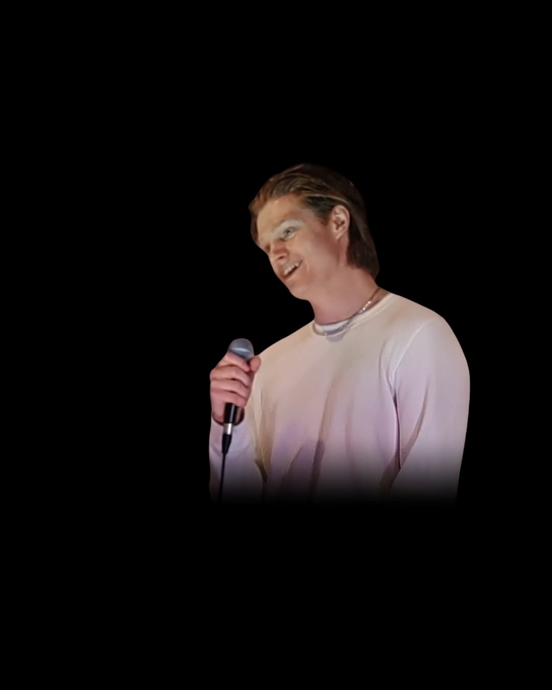 Ty Danielsen on stage with a microphone